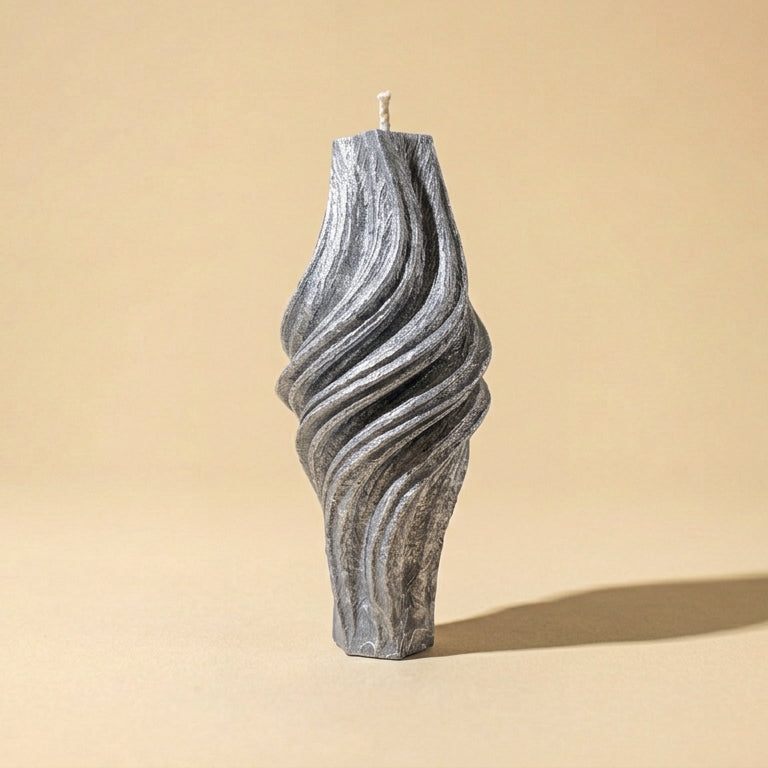 Textured candle on a beige background